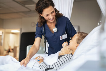 Lovely nurse take care of child at clinic - 548959957