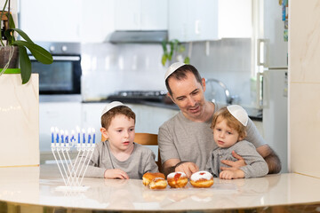 Father and sons with menorah celebrate hanukkah - Jewish religious holiday