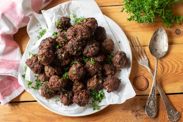 Beef meatballs on wooden table.