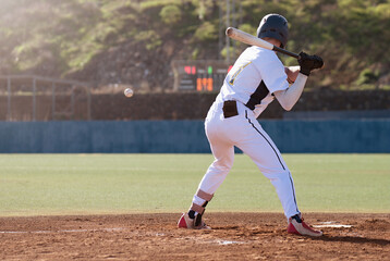 Baseball players in action on the stadium, baseball batter waiting to strike the ball