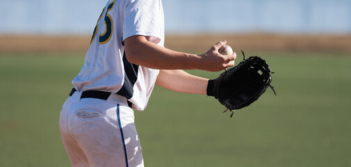 Baseball pitcher ready to pitch in baseball game, college softball player