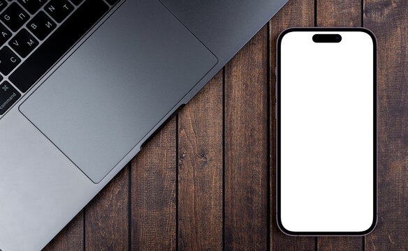 mockup smartphone iPhone 14 Pro Max with blank white screen on the wooden background. Apple is a multinational technology company. Batumi, Georgia - October 5, 2022