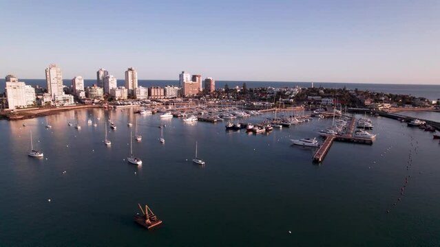 Aerial drone view of sea, harbor, boats and city architecture. Majestic view of resort town of Punta Del Este, Uruguay. High quality 4k footage