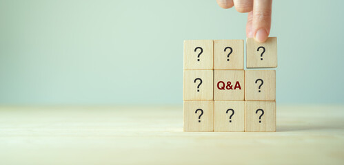 Q and A - an abbreviation of wooden blocks with letters on a gray background. Illustration for...