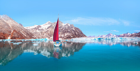 Knud Rasmussen Glacier near Kulusuk with lone yacht with red sails - Greenland, East Greenland