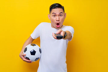 fans to support football sports team.  shocked young Asian man 20s wearing white t-shirt holding a...