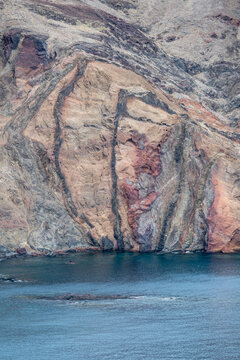 tuft and basalt layers on barren slopes of cove on Atlantic ocean, Baia d Abra, Madeira