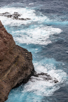 ocean waves dashing on volcanic cliffs at Ponta do Rosto, Madeira