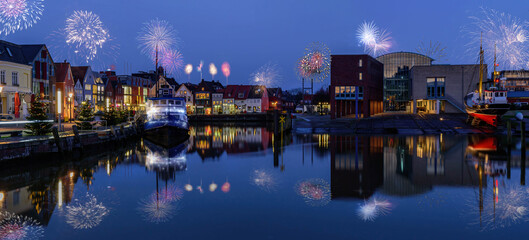 New Year celebrations on New Years Eve with fireworks. Panorama view of festive lighting with...