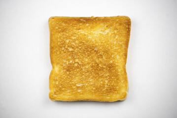 Toasted slice of bread on a white background. Cooked in a toaster.