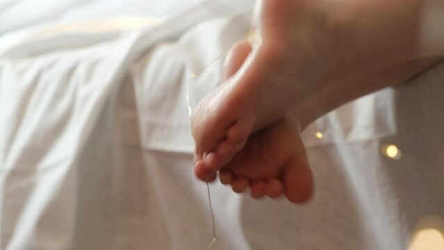 Child feet and flashlights Christmas barefoot concept with copy space. Happy Xmas holiday relax concept. 4k