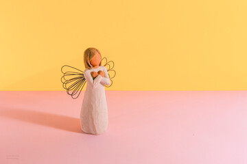 Angel on Pink and Yellow Background