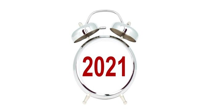 the value 2022 changes to the value of the new year 2023 on a blank face of a chrome alarm clock standing on a white background