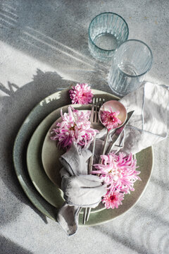 Overhead view of a formal place setting decorated with pink chrysanthemum flowers
