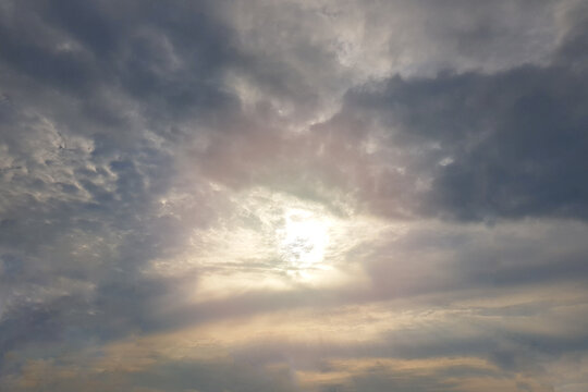 Sun against grey storm clouds
