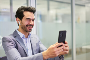 Obraz na płótnie Canvas Business man using smartphone during a video conference