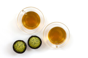 Jasmine tea in a cup and teapot on the table from above, jasmine flowers and dried leaves, herbal tea, healthy food, white background