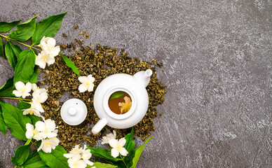 jasmine flower tea in cups and teapot, herbal drink, dried jasmine leaves and beautiful flowers,...