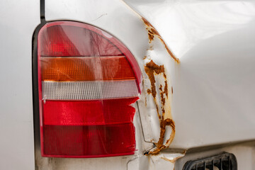 Wrinkled rear fender of a car with a damaged headlight