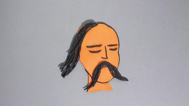 Plasticine stop motion animation, plasticine portrait of a Cossack, Ukrainian national symbol of freedom. Specific hairstyle long forelock and mustache develop in the wind on a gray background