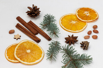 Obraz na płótnie Canvas Fir sprigs and cones, cinnamon sticks and dry orange slices.