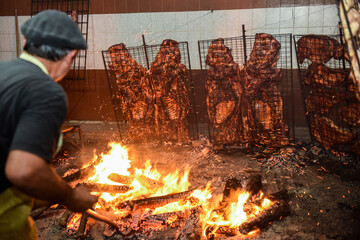 Gaucho roast barbecue, sausage and cow ribs, traditional argentine cuisine, Patagonia, Argentina. - obrazy, fototapety, plakaty