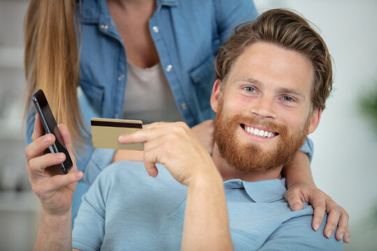 man shopping online with credit card and mobile phone