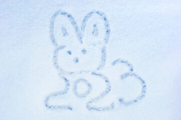 Rabbit in the snow. Symbol of 2023 of the Chinese calendar. Idea logo for merry christmas or new year greeting card. Holiday concept in minimalist style. Drawing of the zodiac sign eared rabbit