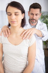 relaxed woman receiving back massage in wellness center