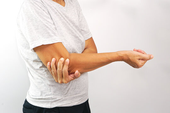 Woman suffering from elbow pain on white background. Healthcare and office syndrome concept.