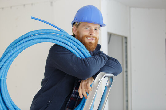 a plumber smiling at camera