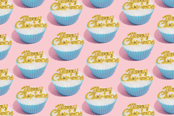 Retro winter holidays pattern of pastel blue baking or cupcake cup with snow and Merry Christmas greetings on pastel pink background. Vintage aesthetic Xmas concept.