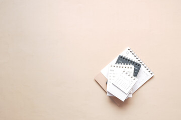 deadline concept with stack of calendar and pencil on color background 