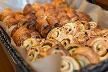 A lot of sweet pastries in baskets on the buffet table. Business breakfasts and catering at events....