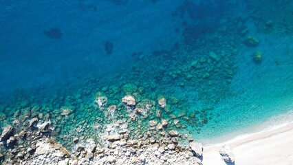 A bird's eye view of a deserted beach The white sandy coastline Submerged cliffs