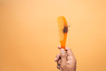 Hair loss in orange color comb, hair fall everyday serious problem, 
