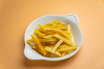 Delicious French fries on an orange background
