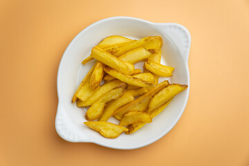 Delicious French fries on an orange background
