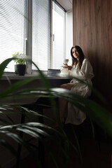 Obraz premium woman drinking coffee in the morning at home. Beautifull morning at cozy home