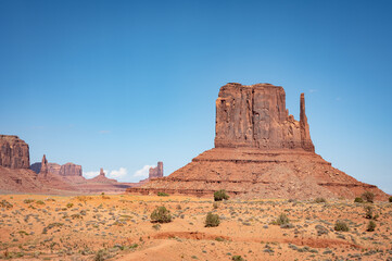 Nice desert landscape with rocky Monument Valley. It's a sunny summer day with blue sky