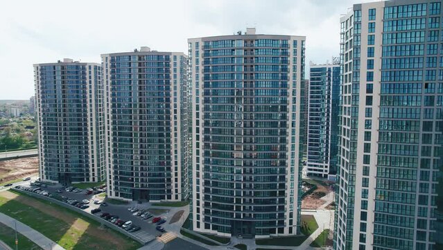 Shooting from a quadcopter of a number of high-rise residential buildings in a new microdistrict with parking lots