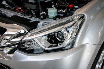 Left projector headlight of car