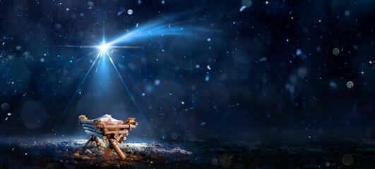 Nativity Scene - Birth Of Jesus Christ With Manger In Snowy Night And Starry Sky - Abstract...