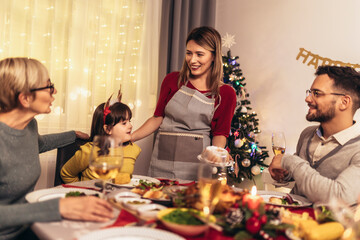 Happy multi-generation family enjoying in a lunch together at home. Family on Christmas dinner at home