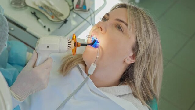 dentist at work. polymerization of the filling with a special lamp