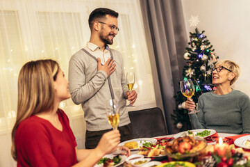 Happy multi-generation family enjoying in a lunch together at home. Family on Christmas dinner at home