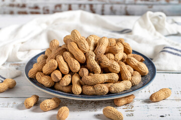 Peanut in shell on wooden background. Healthy food.