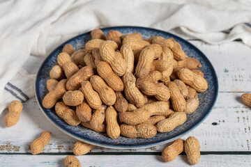 Peanut in shell on wooden background. Healthy food.