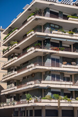 Beautiful cozy houses with large balconies with indoor green plants. Urban improvement of the city of Salerno, Italy. Eco-life in the city, home jungle.