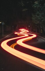 Vertical long exposure shot of the light trails on the road at night